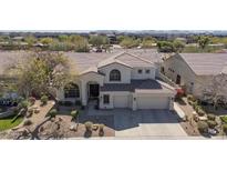 Beautiful two-story home featuring a well-manicured yard and a spacious three-car garage at 7527 E Nestling Way, Scottsdale, AZ 85255