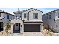 Stunning two-story home with a gray stucco facade, dark gray tiled roof and spacious two car garage at 8000 W Griswold Rd, Peoria, AZ 85345