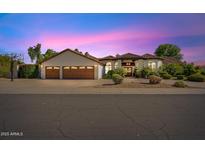 Beautiful single-story home with three-car garage and lush landscaping at 10205 E Corrine Dr, Scottsdale, AZ 85260