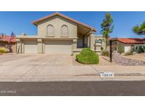 Charming home with a red tiled roof, three-car garage, and well maintained desert landscaping at 12813 S 38Th St, Phoenix, AZ 85044