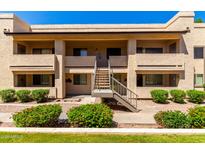 Inviting two-story condo complex featuring manicured landscaping and a charming staircase entryway at 145 N 74Th St # 251, Mesa, AZ 85207