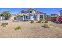 Charming two-story home featuring desert landscaping, decorative stone accents, and a welcoming front entrance at 1937 W Burgess Ln, Phoenix, AZ 85041