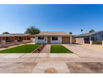 Charming single-story home featuring a well-manicured front yard and attached garage at 2443 E Randall Dr, Tempe, AZ 85288