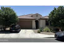 Charming single-story home with a well-manicured lawn and a two-car garage at 25931 W Deer Valley Rd, Buckeye, AZ 85396