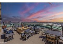 Relaxing rooftop deck showcases amazing city views, comfortable seating, and a cozy fire pit at 310 S 4Th St # 1601, Phoenix, AZ 85004