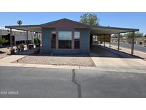 Charming single-story home featuring a covered carport and low-maintenance rock landscaping at 3330 E Main St # 121, Mesa, AZ 85213