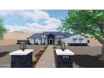 New modern farmhouse featuring desert landscaping, a gray roof, brick pillars, and a walkway to the front door at 35809 N Evermore Madison St, San Tan Valley, AZ 85140