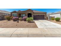 Charming single-story home featuring a gravel front yard, desert landscaping, and a two-car garage at 38005 W Montserrat St, Maricopa, AZ 85138