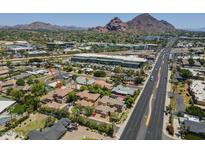 Beautiful aerial view of the home with lush landscaping and city views at 3812 E Camelback Rd, Phoenix, AZ 85018