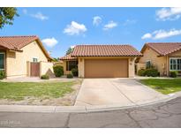 Charming single-level home with a well-maintained lawn, a two-car garage and a terra cotta tile roof at 4790 E Navajo St, Phoenix, AZ 85044