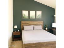 Cozy bedroom featuring modern decor, natural wood headboard, and a calming forest-themed art arrangement at 4901 E Kelton Ln # 1270, Scottsdale, AZ 85254