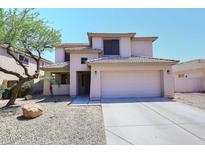 Charming two-story home features a spacious driveway and well-maintained desert landscaping at 537 S 153Rd Ln, Goodyear, AZ 85338