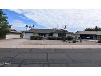 Charming single-story home featuring a well-kept desert landscape and a two-car garage at 5720 E University Dr, Mesa, AZ 85205