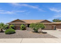 Charming single-story home featuring a well-maintained lawn, mature landscaping, and a two-car garage at 6546 E Dallas St, Mesa, AZ 85205