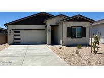Charming single-story home featuring a modern garage door and a well-maintained, xeriscaped front yard at 658 S Maricopa Rd, Florence, AZ 85132