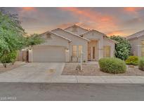 Charming single-story home with a two-car garage and low-maintenance desert landscaping at 8968 W Adam Ave, Peoria, AZ 85382