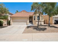 Charming single-story home featuring a terracotta tile roof, attached garage, and well-maintained desert landscaping at 11256 E Sunnyside Dr, Scottsdale, AZ 85259