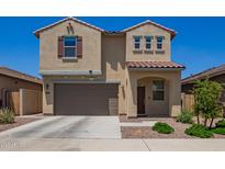 Charming two-story home featuring neutral stucco, a two-car garage, and a well-manicured front yard at 14180 W Willow Ave, Surprise, AZ 85379
