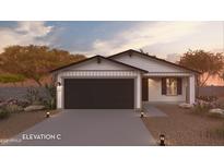 Charming single-story home featuring a two-car garage, desert landscaping, and a welcoming entrance at 17085 N Lariat Rd, Maricopa, AZ 85138