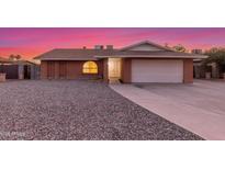 Charming single-story brick home featuring a two-car garage and low-maintenance gravel front yard at 17220 N 55Th Ave, Glendale, AZ 85308