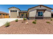 Charming single-story home featuring a neutral stucco exterior and a well-manicured front yard at 17324 W Royal Palm Rd, Waddell, AZ 85355