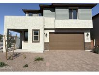 Two-story home featuring a two-car garage and low-maintenance desert landscaping at 17989 W Lupine Ave, Goodyear, AZ 85338