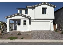 Beautiful two-story home showcasing modern white exterior and a welcoming covered front porch at 18061 W Lupine Ave, Goodyear, AZ 85338