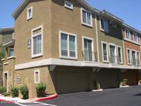 Stylish townhome featuring a private garage, balcony and well-maintained landscaping at 18250 N Cave Creek Rd # 123, Phoenix, AZ 85032