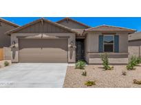 Charming single-story home featuring a low maintenance yard and a two-car garage at 18374 W Poston Dr, Surprise, AZ 85387