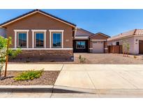 Beautiful single-story home featuring a charming brown exterior with stone accents, complemented by a well-maintained, desert-friendly landscape at 21845 E Bonanza Ct, Queen Creek, AZ 85142