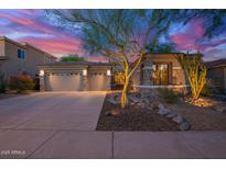 Charming home featuring a desert landscaped front yard, stone accents, and a spacious three-car garage at 22847 N 53Rd E St, Phoenix, AZ 85054