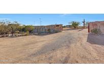 Gated entrance to property featuring desert landscaping and stone walls at 28758 N Ashbrook Ln, San Tan Valley, AZ 85144