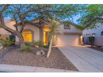 Charming single-story home featuring desert landscaping and a two-car garage at 3055 N Red Mtn # 122, Mesa, AZ 85207