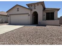 Inviting single-story home featuring desert landscaping, a two-car garage, and a covered entryway at 4117 W Allen St, Laveen, AZ 85339