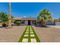 Charming home with manicured desert landscaping and a walkway to the front door at 4932 E Kathleen Rd, Scottsdale, AZ 85254