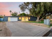 Contemporary home showcasing a sleek design, xeriscaping, and inviting curb appeal, set against a picturesque sky at 6746 E Monterosa St, Scottsdale, AZ 85251