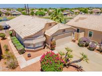 Charming home featuring a two-car garage, meticulous landscaping and a tile roof at 10526 W Tonopah Dr, Peoria, AZ 85382