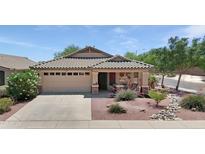 Charming single-story home featuring a well-manicured front yard with desert landscaping and an attached two-car garage at 16661 W Central St, Surprise, AZ 85388