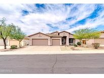 Charming single-Gathering home features a three-car garage, desert landscaping, and a welcoming entrance at 18633 W Mcneil St, Goodyear, AZ 85338