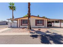 Charming single-story home with mature landscaping and a convenient carport for covered parking at 245 S 56Th St # 135, Mesa, AZ 85206