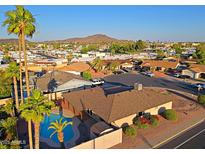Gorgeous aerial view of a home with a beautiful pool surrounded by lush greenery and mature trees at 3054 W Redfield Rd, Phoenix, AZ 85053