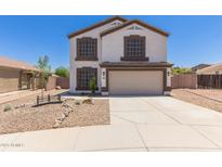 Charming two-story home with a well-manicured front yard and a two-car garage, painted in neutral colors at 33287 N Windmill Run, San Tan Valley, AZ 85144
