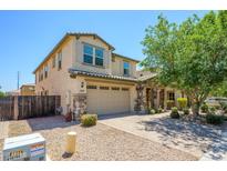 Charming two-story home featuring a stone facade, well-maintained landscaping, and a two-car garage at 3361 E Wisteria Pl, Chandler, AZ 85286