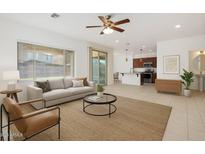 Open-concept living room with modern furnishings seamlessly connected to the kitchen area at 3361 E Wisteria Pl, Chandler, AZ 85286