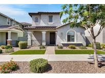 Charming two-story home showcasing a well-manicured lawn, inviting entry, and detailed architectural features at 4332 E Boston St, Gilbert, AZ 85295