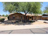 Charming single-story brick home featuring mature shade trees and a low maintenance front yard at 4516 E Willow Ave, Phoenix, AZ 85032