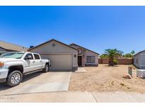 Charming single-story home with a two-car garage and desert landscaping at 4741 N 85Th Ave, Phoenix, AZ 85037