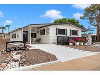 Charming home featuring a bridge walkway, black trim, and fresh flowers at 5534 E Player Pl, Mesa, AZ 85215