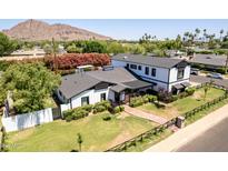 Stunning aerial view of a modern farmhouse-style home with manicured lawn and lush landscaping at 6196 E Calle Camelia --, Scottsdale, AZ 85251