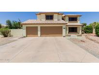 Inviting two-story home with a tile roof and three-car garage at 6276 N 75Th Ln, Glendale, AZ 85303